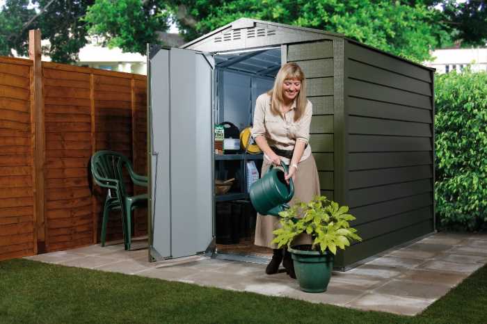 Woman watering plant in front of a garden storage system Trimetals